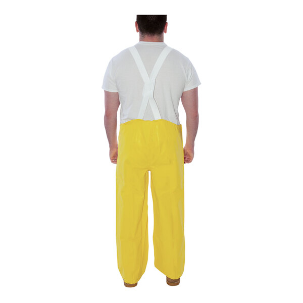 A man wearing Tingley yellow overalls.