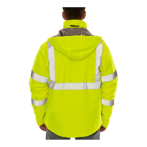 A person wearing a Tingley yellow and black industrial work jacket.