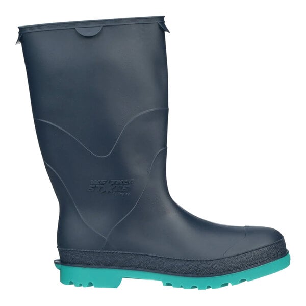 A close up of Tingley youth's blue rubber rain boots with green trim.