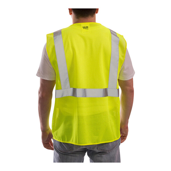 A man wearing a Tingley lime mesh safety vest with zipper closure.