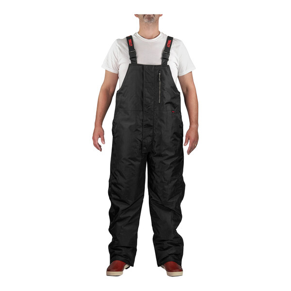 A person wearing Tingley black overalls.
