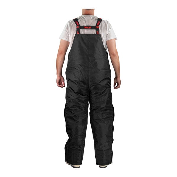A person wearing Tingley black insulated overalls.