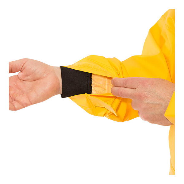 A person wearing a Tingley Weather-Tuff yellow rain jacket.
