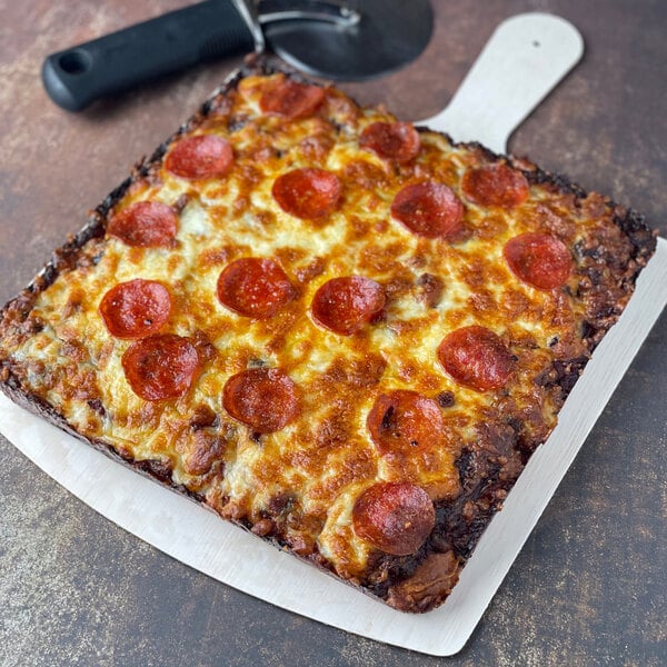 A square pizza on a VerTerra balsa wood cheese board.