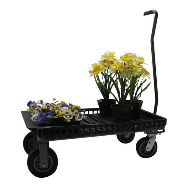 A black R.W. Rogers Company wagon cart with yellow and white flowers in pots on it.