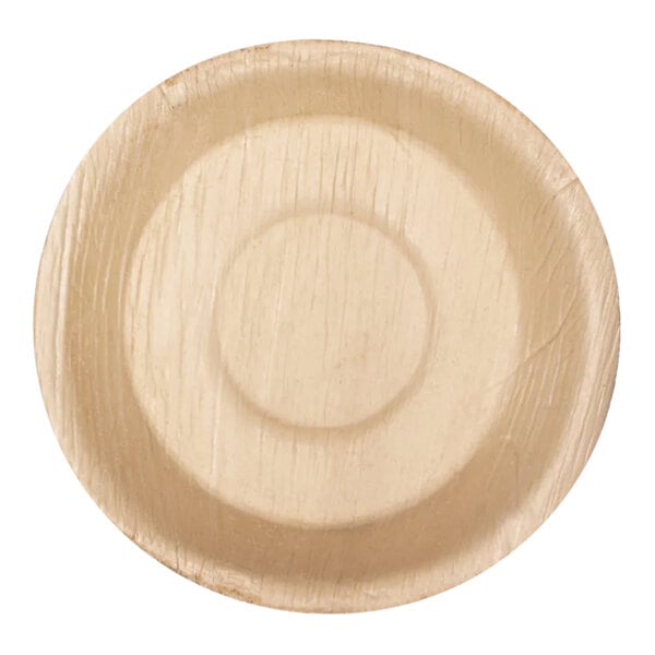 A round VerTerra palm leaf bowl on a wood surface.