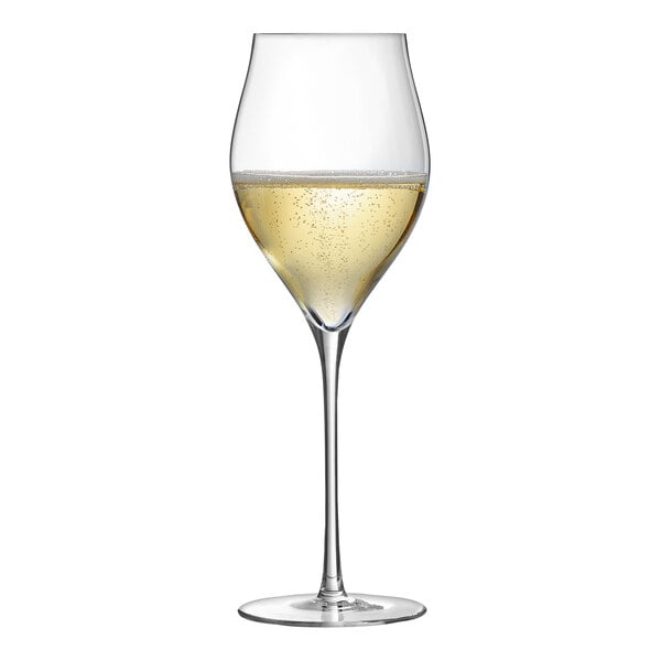 A Chef & Sommelier Exaltation wine glass filled with white wine on a white background.