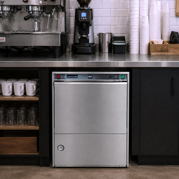 A stainless steel Champion UH-140B high temperature undercounter dishwasher installed in a commercial kitchen setting.