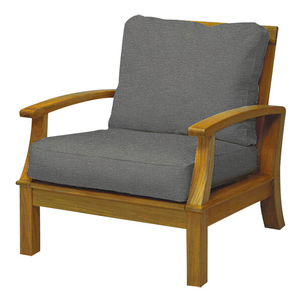 A Three Birds Casual Monterey wooden arm chair with grey cushions.