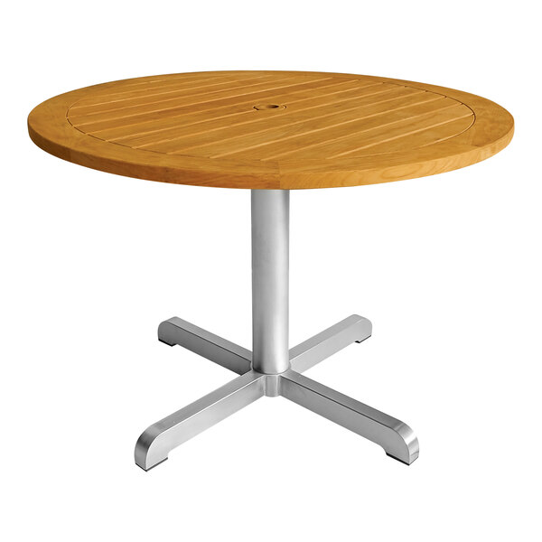 A Three Birds Casual round teak table on a silver pedestal base.