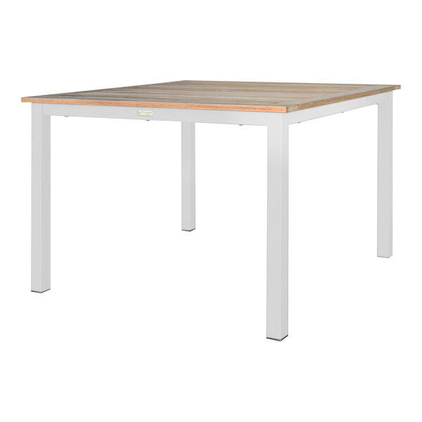 A white table with a teak top and metal legs.