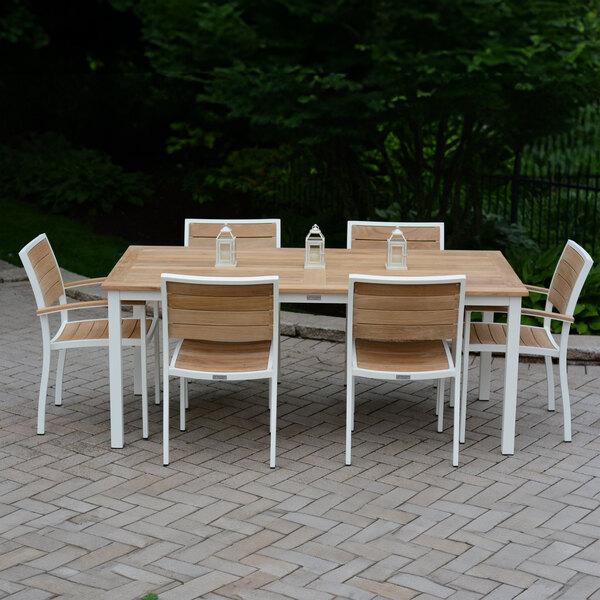 Three Birds Casual SoHo Stacking Side Chair with White Frame on a table and chairs on a brick patio