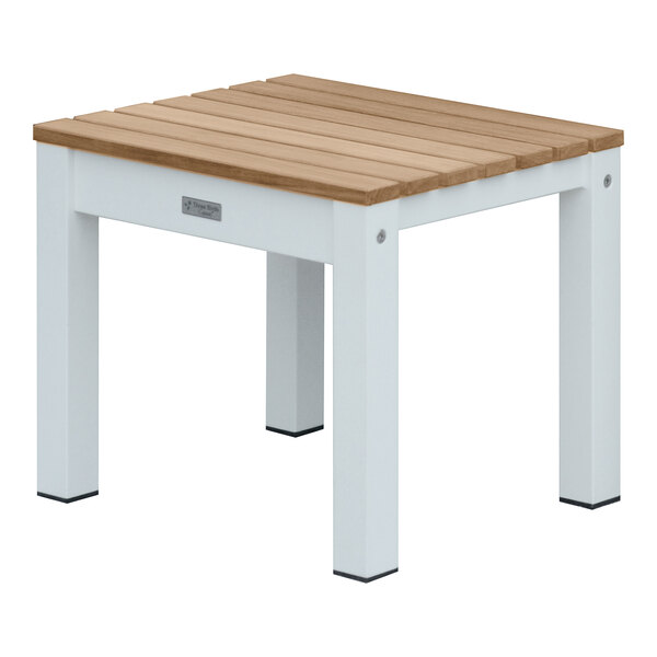 A white and wood Three Birds Casual SoHo backless bench on a white and brown table.