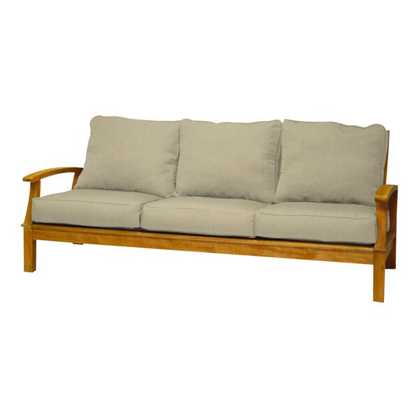 A Three Birds Casual Monterey wooden sofa with beige cushions on it.