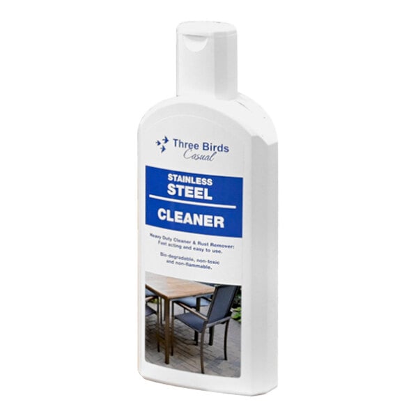 A white bottle of Three Birds Casual stainless steel cleaner with a blue label on a table outdoors.