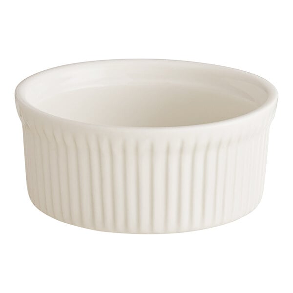An Acopa ivory fluted porcelain souffle dish with a small rim.