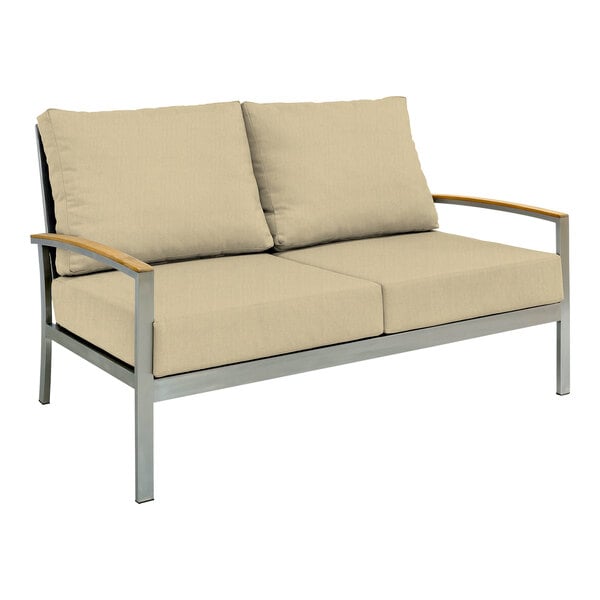 A Three Birds Casual Avanti Sand outdoor sofa with white cushions.