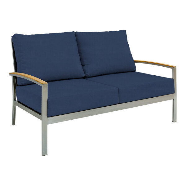 A navy blue Three Birds Casual outdoor sofa with wooden armrests.