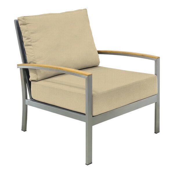 A Three Birds Casual Avanti Sand outdoor arm chair with a cushion on a metal frame.
