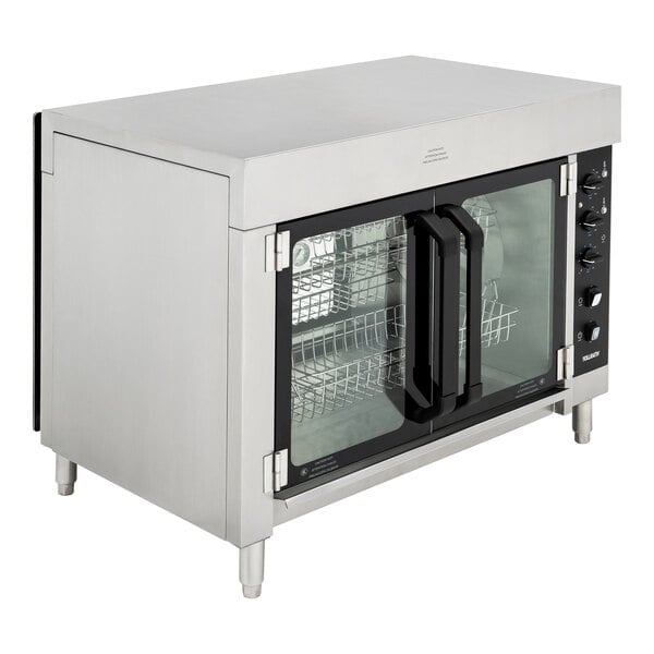 A Vollrath stainless steel countertop rotisserie oven with glass doors.