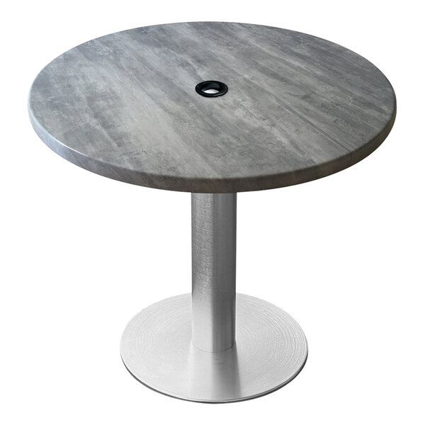 A round grey Holland Bar Stool table with a metal base and umbrella hole.