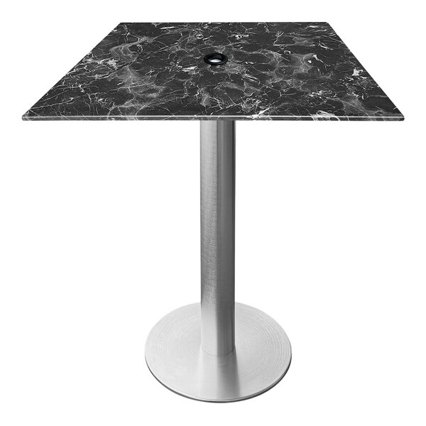 A Holland Bar Stool black marble table with a brushed aluminum base.