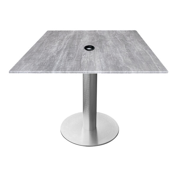 A Holland Bar Stool square table with a round hole in the center for an umbrella.