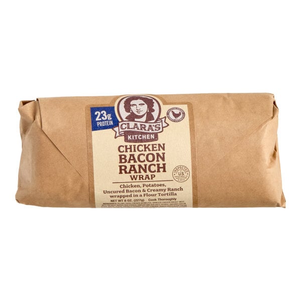 A wrapped Clara's Kitchen Chicken Bacon Ranch Wrap in brown paper packaging.