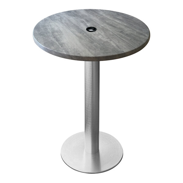 A round grey Holland Bar Stool EnduroTop table with a metal base and umbrella hole.