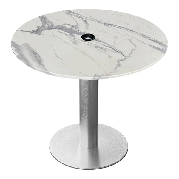 A round white marble table with a brushed aluminum base.