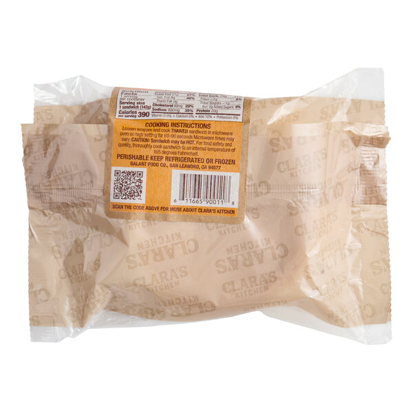 A packaged Clara's Kitchen Chorizo Breakfast Sandwich weighing 5 ounces.