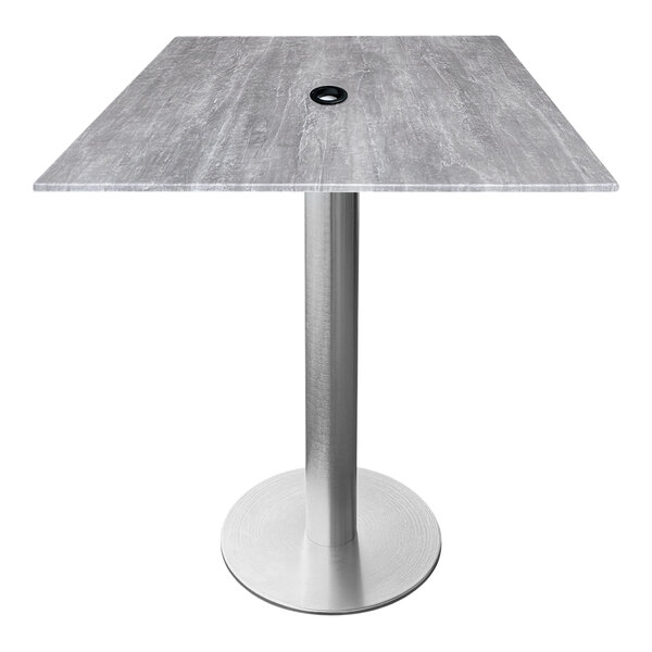 A square table with a metal base and a black top with an umbrella hole.