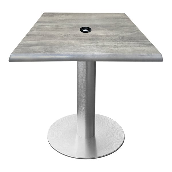 A Holland Bar Stool square table with a brushed aluminum base and umbrella hole.