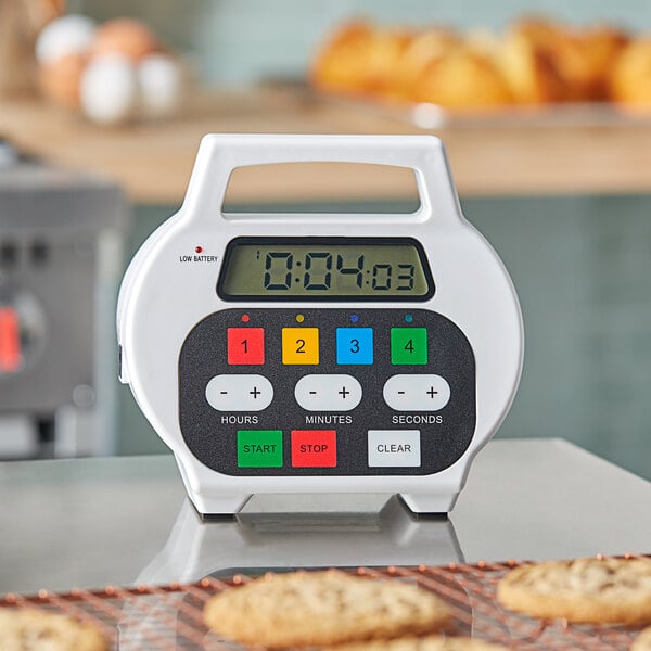 A Chef Master digital timer on a counter with cookies.