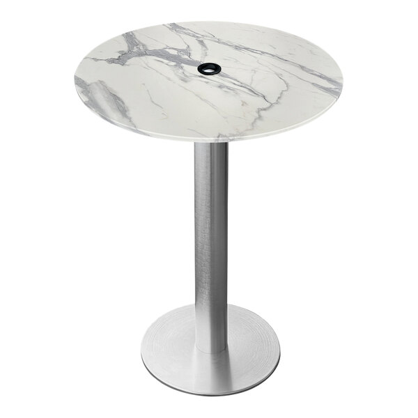 A round white marble table on a brushed aluminum base with an umbrella hole.