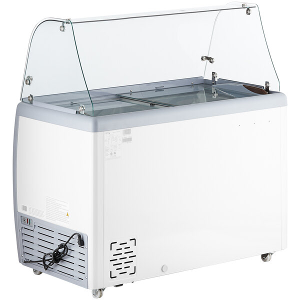 An Avantco ice cream dipping cabinet with a curved glass top on a counter.