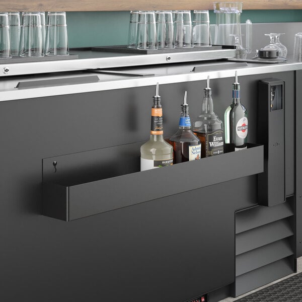 A Steelton single tier speed rail on a bar counter with bottles.