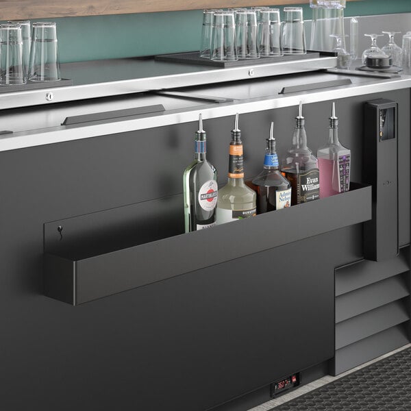 A Steelton single tier speed rail on a bar counter with bottles.