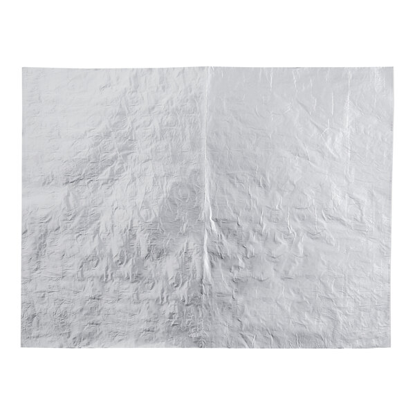 A white sheet of paper with a large piece of silver foil.
