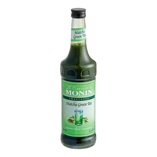 A bottle of Monin Matcha Green Tea Concentrate with green liquid inside.