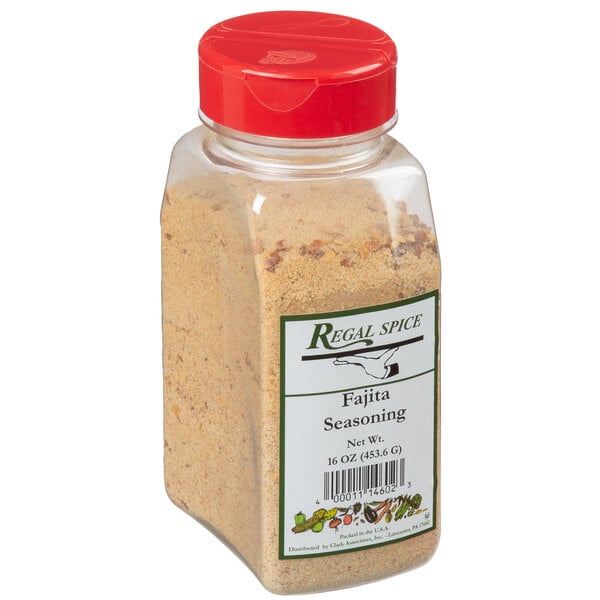 A close-up of a plastic jar of Regal Fajita Seasoning with a red lid.