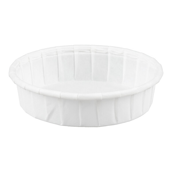 A small, white, round paper souffle or portion cup.