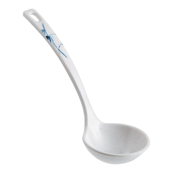 A white Acopa Biru melamine soup ladle with a blue dragonfly design.
