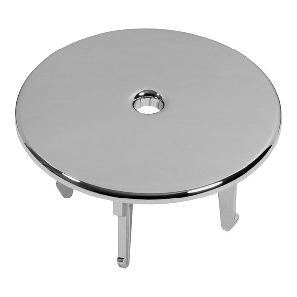 A round silver plastic urinal strainer with a hole in the center.