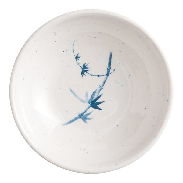 A white sauce dish with blue designs on it.
