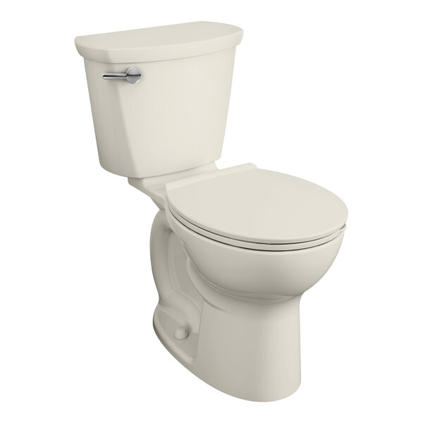 An American Standard linen vitreous china toilet with a seat down.