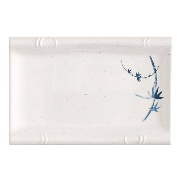 A white rectangular plate with blue bamboo designs.