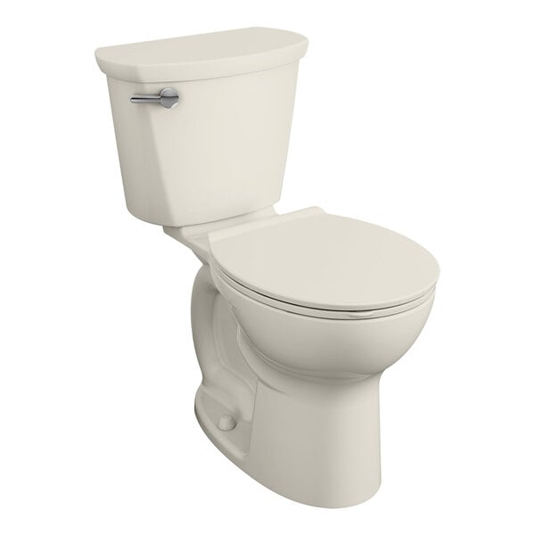 An American Standard linen vitreous china round toilet with the seat down.