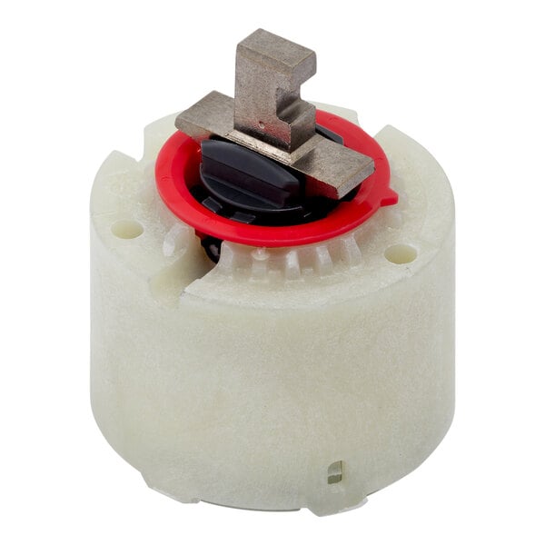 A white and black American Standard volume and temperature control valve cartridge with a red circle.