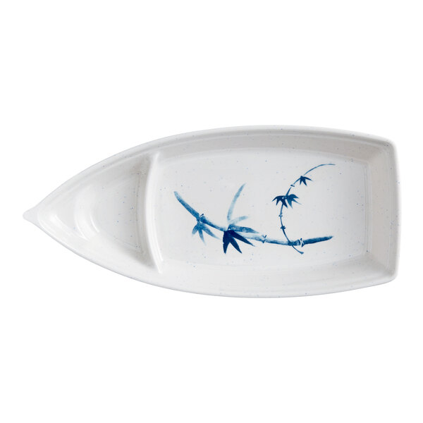 A white plate with blue painted bamboo leaves.